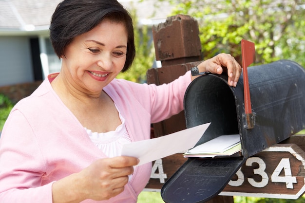 Senior Hispanic Woman Checking Mailbox Smiling