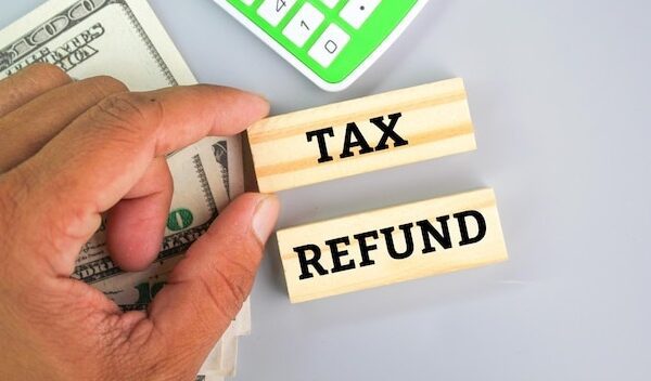 calculator, paper money with the word tax refund. tax refund concept