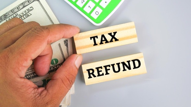 calculator, paper money with the word tax refund. tax refund concept