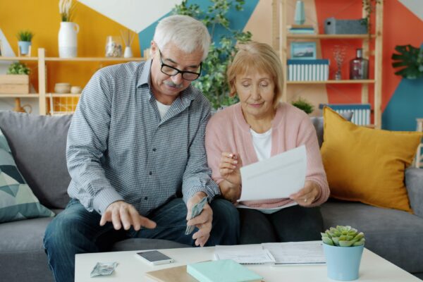Elderly couple reviewing documents at home