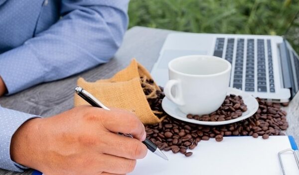 Man holding coffee cup on table