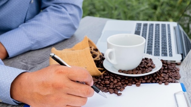 Man holding coffee cup on table