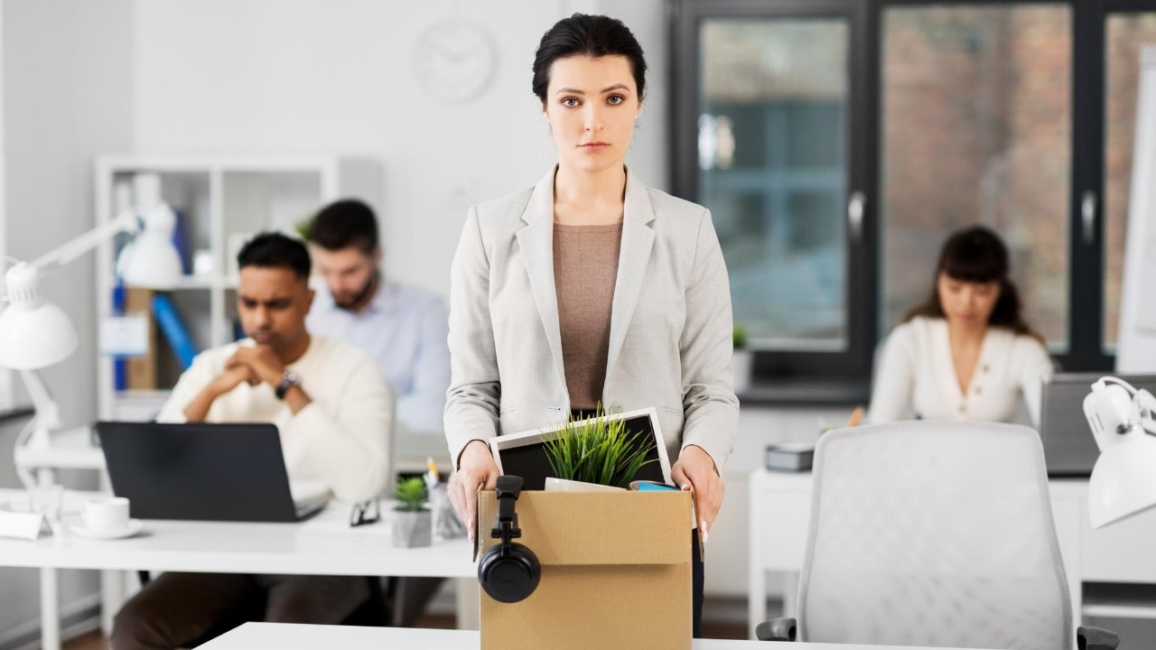 female office worker with box of personal stuff