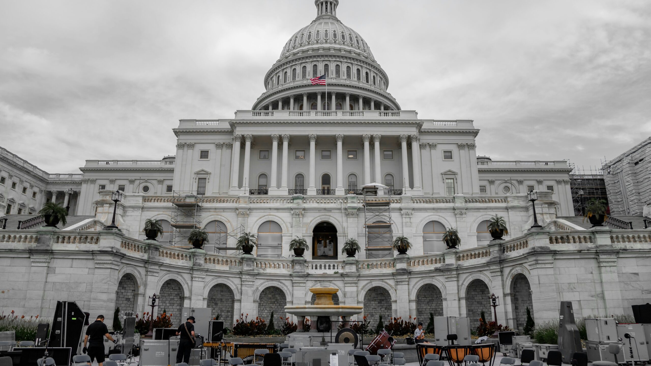 people walking around white concrete building during daytime