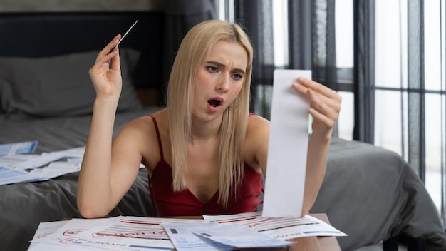 Stress young woman sit at at table pay credit card debt Blithe