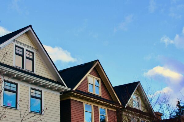 a row of houses with a blue sky in the background