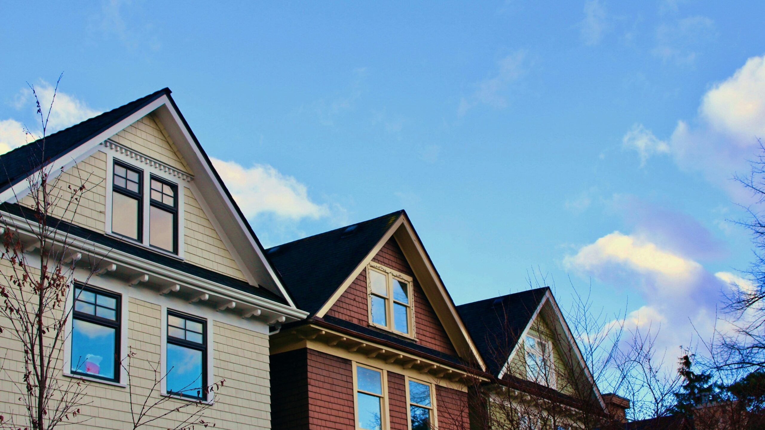 a row of houses with a blue sky in the background