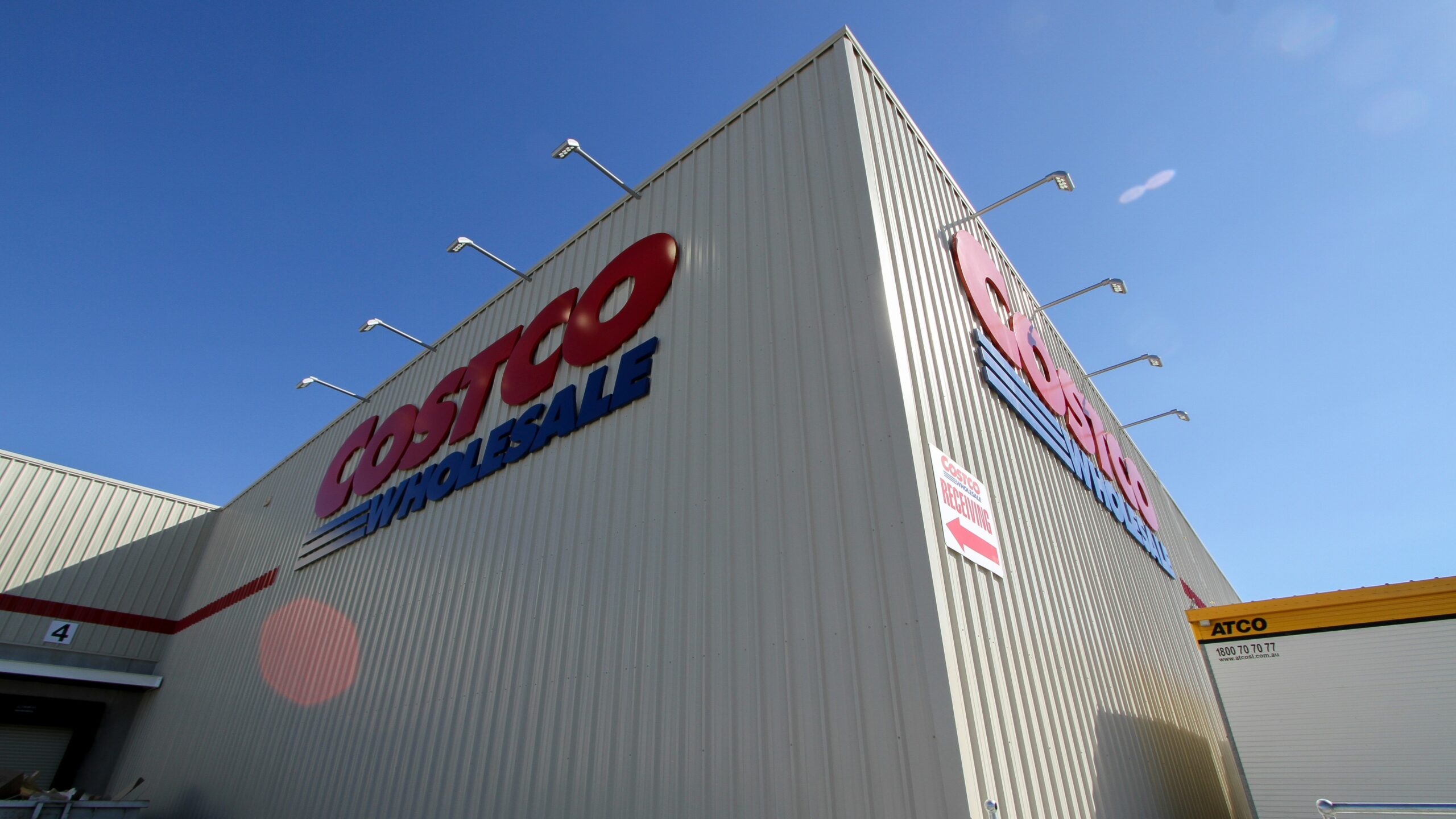 a large white building with a red and blue sign on it