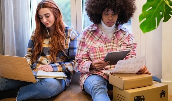 Two women entrepreneurs making packages to send their business orders to their customers Concept business small business teamwork