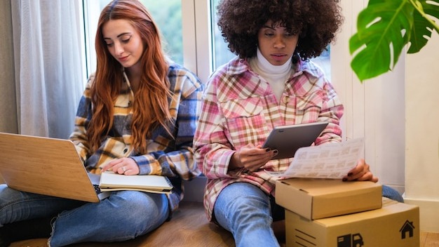 Two women entrepreneurs making packages to send their business orders to their customers Concept business small business teamwork