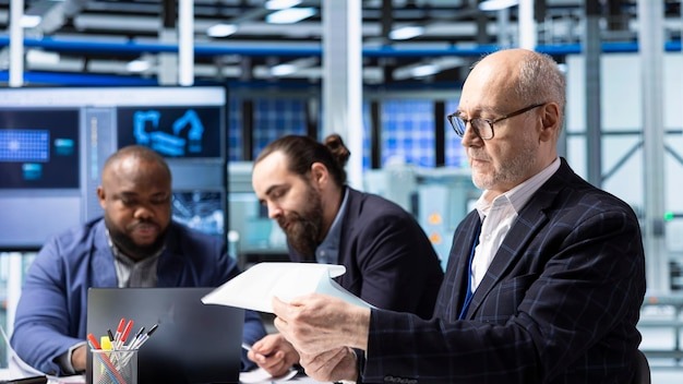 Factory managers and investors analyze technical production data documents