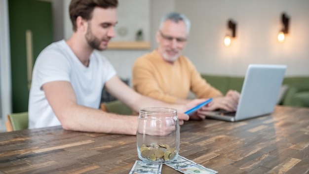 Home office. Two men working in a home office and looking involved