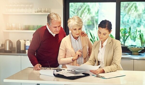 Senior couple accountant and paperwork for finance budget discussion or consultation at home Elderly man and woman with consultant or lawyer for financial planning savings investment or documents