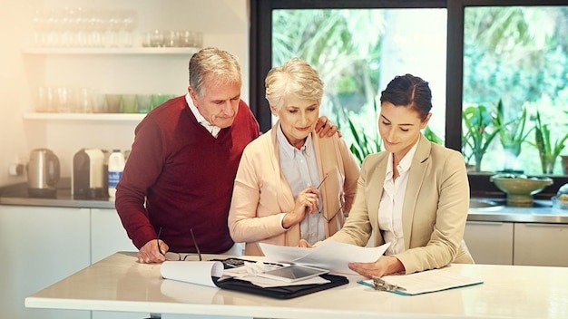 Senior couple accountant and paperwork for finance budget discussion or consultation at home Elderly man and woman with consultant or lawyer for financial planning savings investment or documents