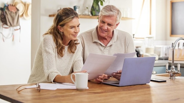 Retirement finance and couple with budget on laptop satisfied with home expenses in New Zealand Happy positive and married senior people checking financial documents for investment payment