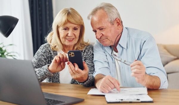 With laptop on the table Senior man and woman is together at home