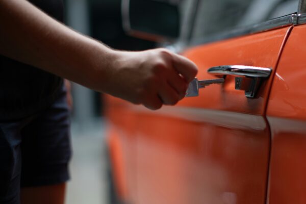 woman riding on vehicle holding 5 banknote