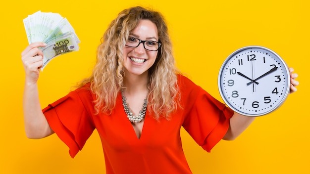 Woman in dress with clocks and fan of banknotes