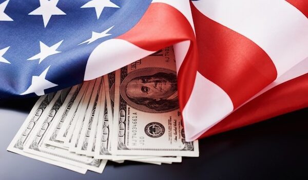 USA national flag and currency usd money banknotes on a dark . Business and finance