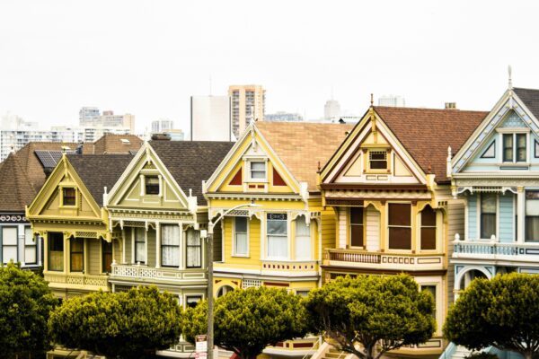 a red truck parked in front of a row of houses