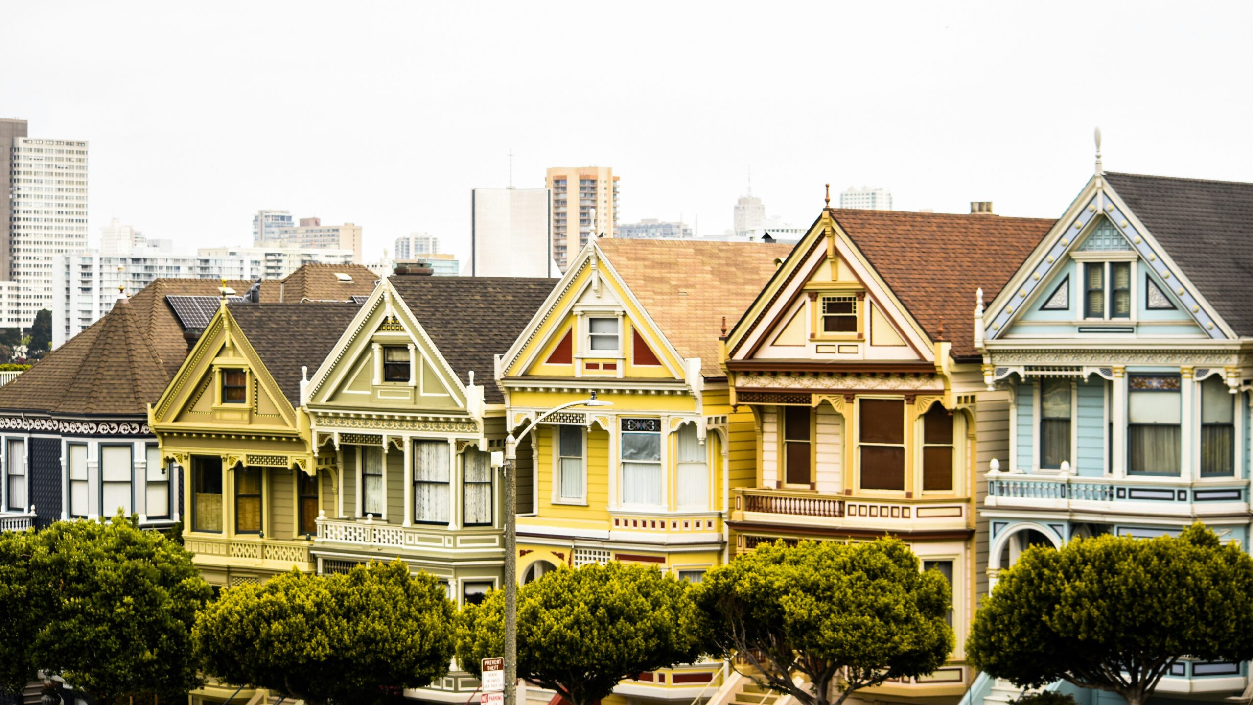a red truck parked in front of a row of houses