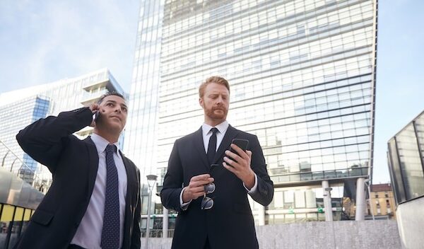 Business people working outside office building