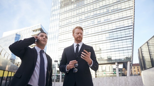 Business people working outside office building