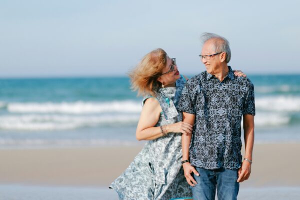 Elderly couple walking on a beach
