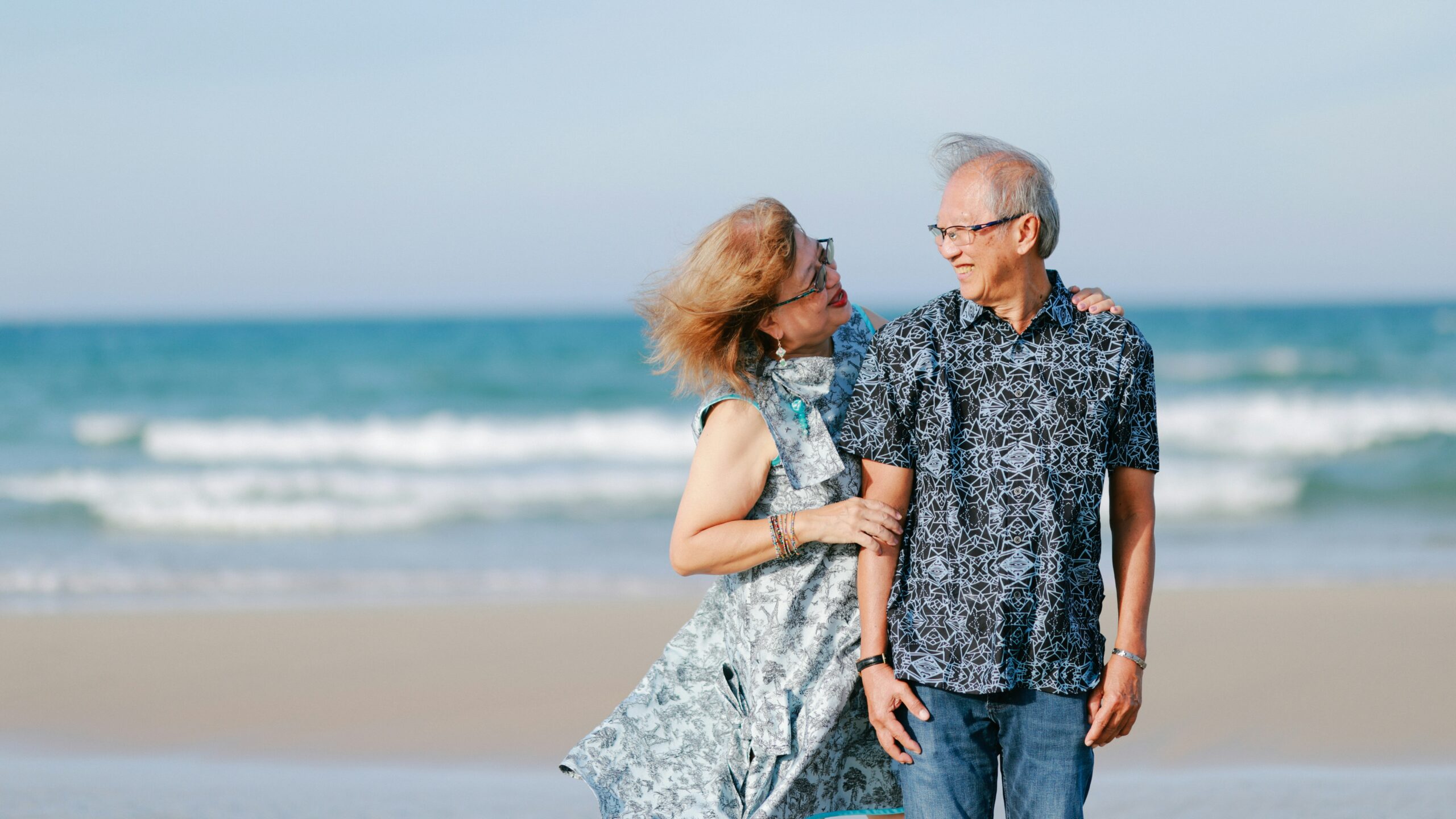 Elderly couple walking on a beach