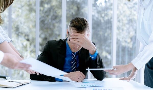 Businessman stressed because of work problems and profit losses