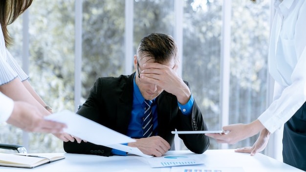 Businessman stressed because of work problems and profit losses