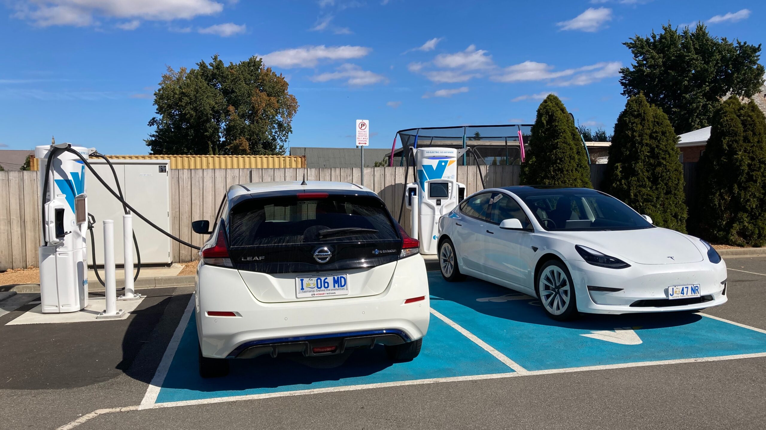 Two electric vehicles at an Evie Networks fast charging station in Campbell Town, Tasmania