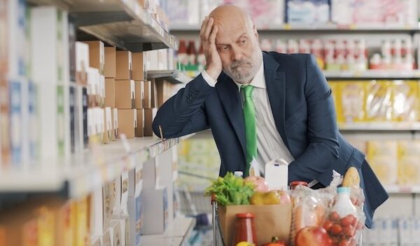 Tired confused man at the supermarket