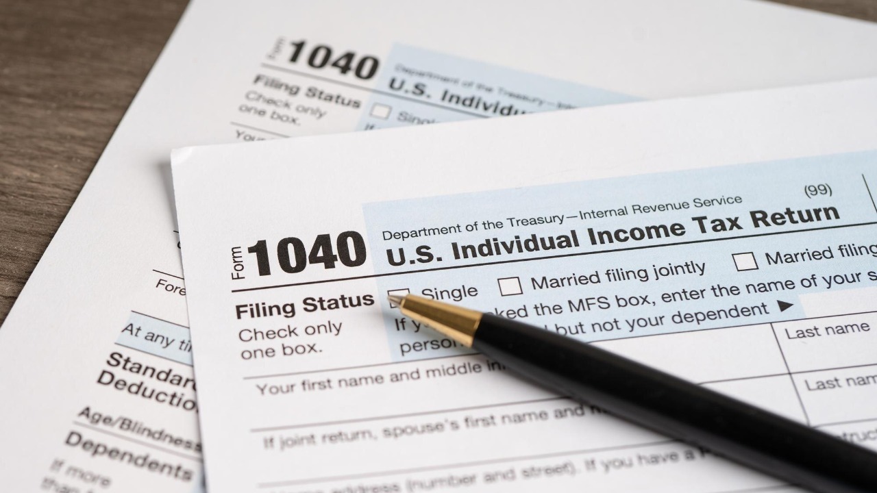 Tax Return form 1040 with pen US Individual Income