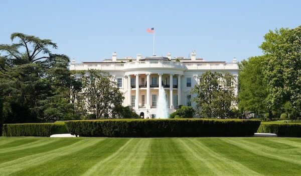 a white house with a flag on the top