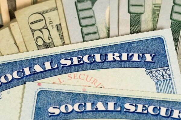 USA Social security cards laid on dollar bills