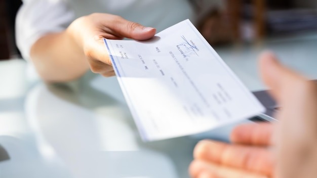 Hand Giving Payroll Compensation Paycheck