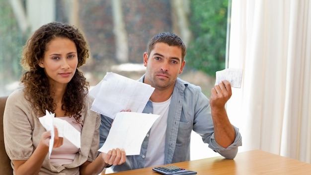 Young couple calculating their domestic bills