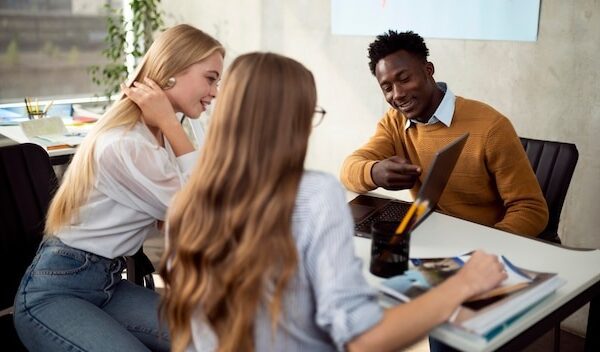 Medium shot people looking at laptop