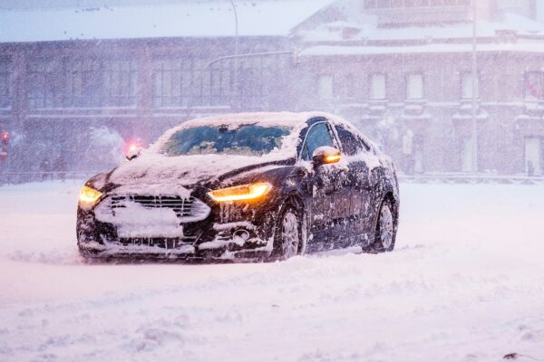 yellow and black sports car on snow covered road during daytime