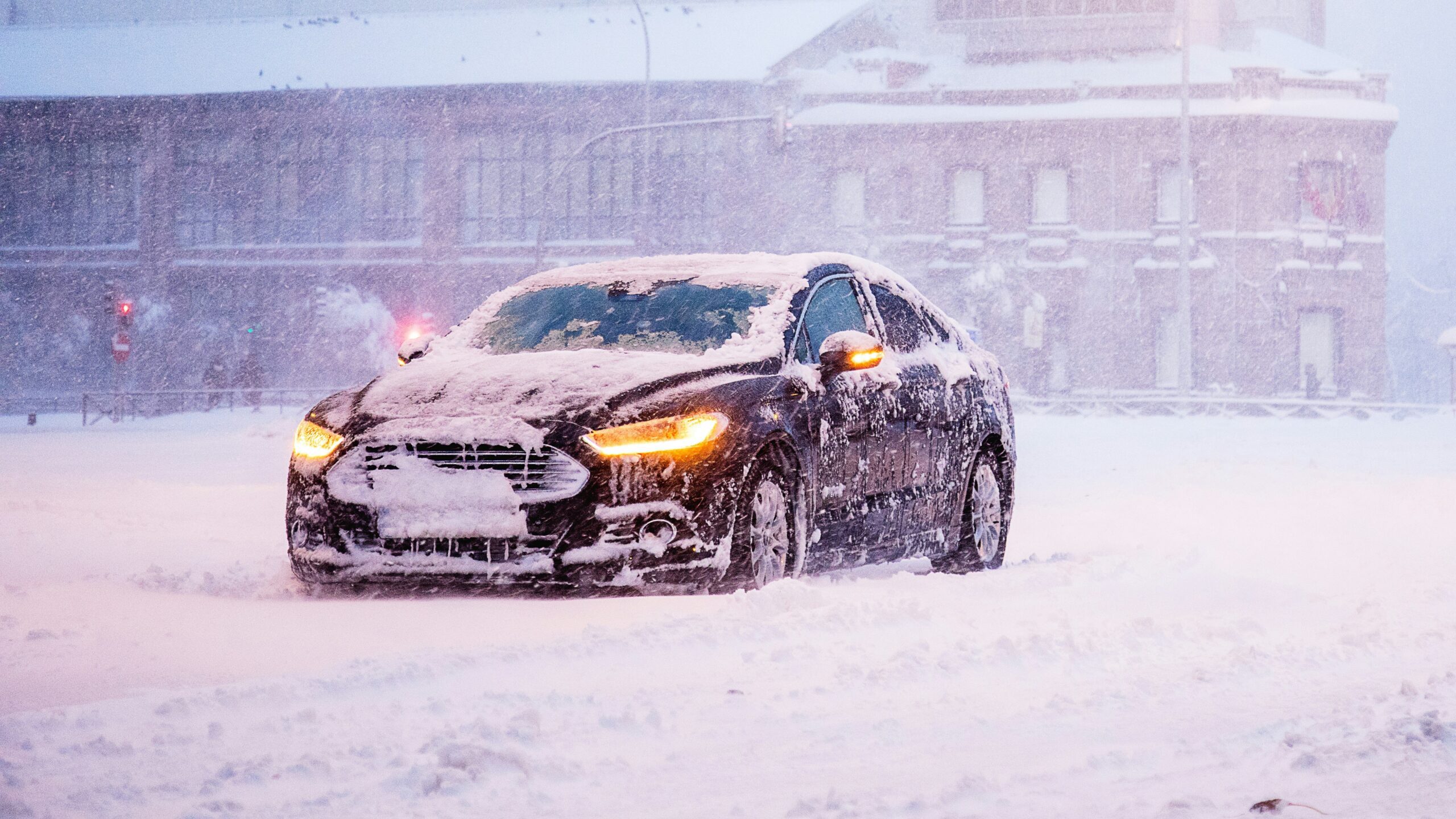 yellow and black sports car on snow covered road during daytime