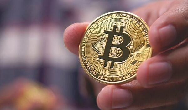 Close-up of hand holding a bitcoin