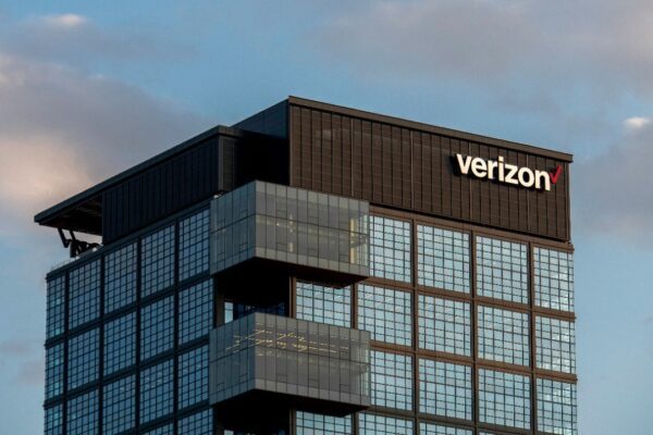 a very tall building with a verizon sign on top