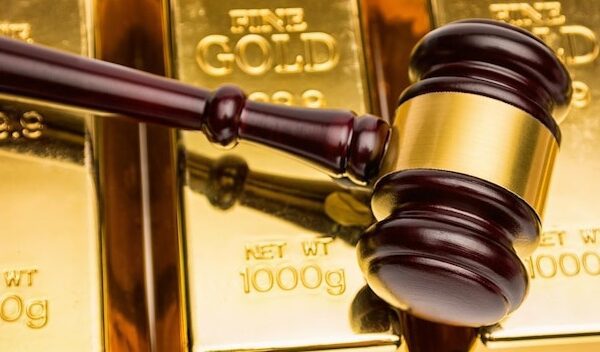 shot from a judge gavel on gold bars. ideal for websites and magazines layouts