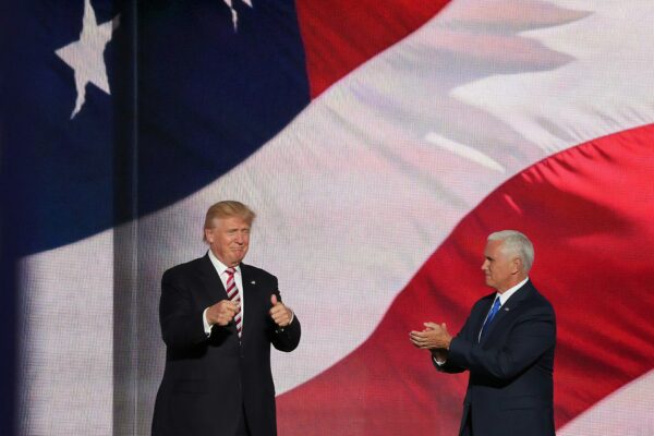 Donald Trump beside man in black suit