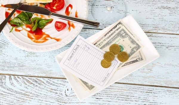 Check and remnants of food on table in restaurant