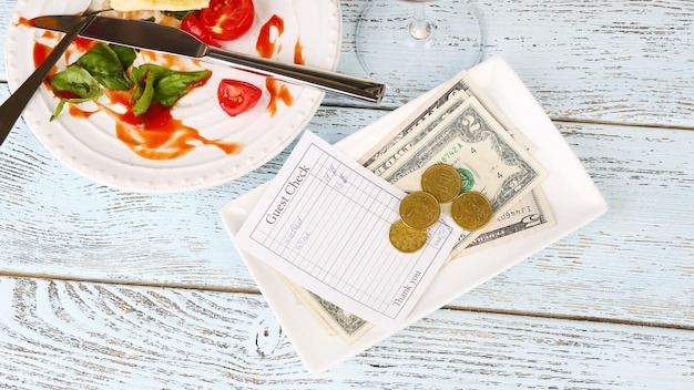 Check and remnants of food on table in restaurant