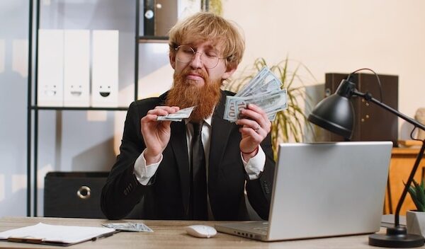 Rich pleased boss businessman waving money dollar cash success career lottery winner income wealth