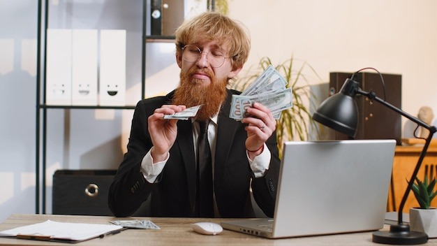 Rich pleased boss businessman waving money dollar cash success career lottery winner income wealth