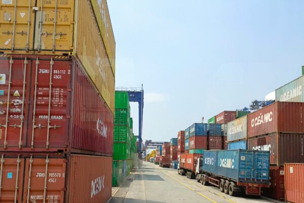 a long line of shipping containers on the side of a road